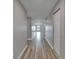 Bright hallway showcasing wood-look flooring, leading to different areas of the home at 5325 Sandy Shell Dr, Apollo Beach, FL 33572