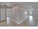 Hallway featuring wood-look floors, neutral walls, and access to different areas of the house at 5325 Sandy Shell Dr, Apollo Beach, FL 33572