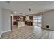 Open concept kitchen featuring wood cabinets, a stone island, and views of the water at 5325 Sandy Shell Dr, Apollo Beach, FL 33572