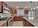 The kitchen features granite counters, stainless appliances, and wood cabinetry at 5325 Sandy Shell Dr, Apollo Beach, FL 33572