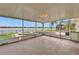 Spacious screened lanai with brick flooring, overlooking the pool, spa, and serene lake at 5325 Sandy Shell Dr, Apollo Beach, FL 33572