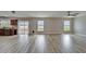 Spacious living room featuring tile floors and large windows with beautiful view of the lake at 5325 Sandy Shell Dr, Apollo Beach, FL 33572