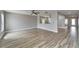 Expansive living room showcases wood-look tile flooring and abundant natural light at 5325 Sandy Shell Dr, Apollo Beach, FL 33572