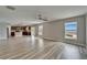 Open floor plan with kitchen and living room area featuring tile floors, windows, and ceiling fan at 5325 Sandy Shell Dr, Apollo Beach, FL 33572