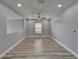 Spacious living room with neutral walls, wood-look floors, and a ceiling fan, offering a relaxing space at 5325 Sandy Shell Dr, Apollo Beach, FL 33572