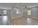 Open-concept living area featuring wood-look floors, neutral walls, and waterfront view for comfortable living at 5325 Sandy Shell Dr, Apollo Beach, FL 33572