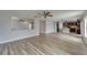 A bright, open-plan living room boasts wood-look tile floors and a ceiling fan at 5325 Sandy Shell Dr, Apollo Beach, FL 33572