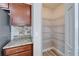 A walk-in pantry equipped with metal shelving for organized storage, conveniently located near the kitchen at 5325 Sandy Shell Dr, Apollo Beach, FL 33572