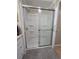 Bathroom shower with frosted glass door, and built in shelving at 5403 Comanche St, Zephyrhills, FL 33542