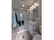 Nicely updated bathroom with gray floors and a modern white vanity at 5403 Comanche St, Zephyrhills, FL 33542