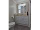 Bathroom vanity with a large mirror and updated fixtures at 5403 Comanche St, Zephyrhills, FL 33542