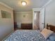 Cozy bedroom featuring neutral walls and a blue patterned bedspread at 5403 Comanche St, Zephyrhills, FL 33542