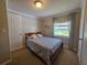 Bedroom featuring bed with blue patterned comforter, neutral walls, and white trim at 5403 Comanche St, Zephyrhills, FL 33542