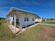 Single-story home with a covered porch and manicured lawn at 5403 Comanche St, Zephyrhills, FL 33542