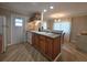 Functional kitchen featuring wood cabinets, laminate flooring, and a convenient breakfast bar at 5403 Comanche St, Zephyrhills, FL 33542