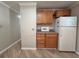 Kitchen featuring wood cabinets, essential appliances, and plenty of storage space at 5403 Comanche St, Zephyrhills, FL 33542