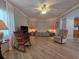 Inviting living room featuring light wood floors, a ceiling fan and a rocking chair at 5403 Comanche St, Zephyrhills, FL 33542