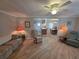 Cozy living room showcasing wood floors that lead into the kitchen and dining area at 5403 Comanche St, Zephyrhills, FL 33542