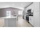 Well-lit kitchen features white cabinetry, stainless steel appliances, and an island with a sink at 5804 Bitter Orange Ave, Tampa, FL 33625