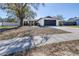 Charming single-story home with well-maintained lawn, dark garage door, and a driveway at 705 Climate Dr, Brandon, FL 33511