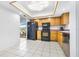 Kitchen featuring tile floors, wooden cabinets, stainless steel appliances, and modern lighting at 705 Climate Dr, Brandon, FL 33511