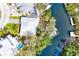 Aerial view of canal-front home with dock, landscaping, and pool at 809 30Th E Ct, Bradenton, FL 34208