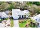 Aerial view of a house with a gray roof, green landscaping, and a paved driveway at 809 30Th E Ct, Bradenton, FL 34208