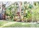 Lush green lawn in backyard with natural Florida landscaping around the sides and back of the property at 809 30Th E Ct, Bradenton, FL 34208