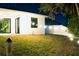 Outdoor space with patio doors, string lights, privacy fence, and a green lawn at 809 30Th E Ct, Bradenton, FL 34208