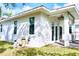 A view of the exterior side of the home with windows and a door leading to the backyard at 809 30Th E Ct, Bradenton, FL 34208