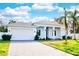 Charming single-story home with a well-manicured lawn, paver driveway, and attached garage at 809 30Th E Ct, Bradenton, FL 34208