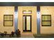 Inviting front entrance with classic exterior lights, a modern black door and well-lit walkway at 809 30Th E Ct, Bradenton, FL 34208