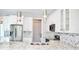 Modern kitchen with stainless steel appliances, mosaic backsplash, white cabinets, and granite countertops at 809 30Th E Ct, Bradenton, FL 34208