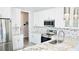 Bright kitchen featuring granite countertops, stainless steel appliances, and white cabinets at 809 30Th E Ct, Bradenton, FL 34208