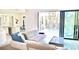 Modern living room boasts a plush sofa and sliding glass doors that overlook a refreshing swimming pool at 809 30Th E Ct, Bradenton, FL 34208