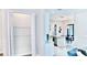 Walk-in pantry with wire shelving next to an open floor plan featuring the kitchen and dining area at 809 30Th E Ct, Bradenton, FL 34208
