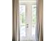 Inviting patio door with neutral-toned curtains offers a seamless transition to the outdoors at 809 30Th E Ct, Bradenton, FL 34208
