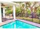 Inviting pool area is surrounded by a secure fence and lush greenery, ensuring privacy at 809 30Th E Ct, Bradenton, FL 34208