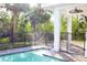 Backyard swimming pool area surrounded by lush landscaping at 809 30Th E Ct, Bradenton, FL 34208