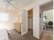 Bedroom featuring neutral walls and carpet, a ceiling fan, closet, and light wood furnishings at 8623 140Th Way, Seminole, FL 33776