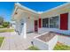 Inviting front entrance featuring a tiled porch and white accent planter at 8623 140Th Way, Seminole, FL 33776