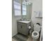 Clean bathroom with granite counters, updated fixtures, large window, and a tiled floor at 9208 Hillcroft Dr, Riverview, FL 33578