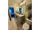 Bright bathroom featuring a double vanity with granite counters, decorative wall art, and tiled floors at 9208 Hillcroft Dr, Riverview, FL 33578