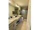 Bathroom featuring double sinks, granite countertops, a tiled shower, and tile floors at 9208 Hillcroft Dr, Riverview, FL 33578