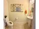 Stylish powder room with a pedestal sink, decorative wall art, tiled floors, and modern toilet at 9208 Hillcroft Dr, Riverview, FL 33578