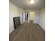 Bright bedroom featuring neutral walls, wood-look floors, and closet, offering a clean and modern living space at 9208 Hillcroft Dr, Riverview, FL 33578