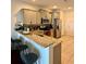 Kitchen featuring stainless steel appliances, granite counters, an island with bar seating, and light grey cabinets at 9208 Hillcroft Dr, Riverview, FL 33578