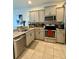 Close up of the Kitchen featuring stainless steel appliances, granite counters, and light grey cabinets at 9208 Hillcroft Dr, Riverview, FL 33578