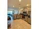 Well-lit kitchen featuring stainless steel appliances, granite counters, tile flooring, and an open floorplan at 9208 Hillcroft Dr, Riverview, FL 33578