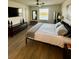 Main bedroom features a ceiling fan, television, and a window with a view of the water at 9208 Hillcroft Dr, Riverview, FL 33578